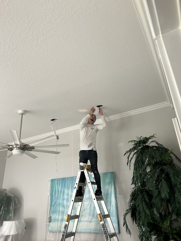 AMR worker completing ceiling lighting installation